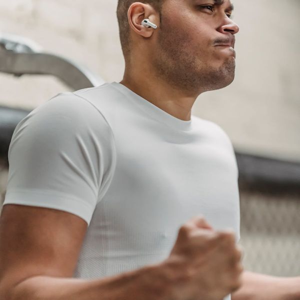 A man in deep concentration during a workout, focused on his form.